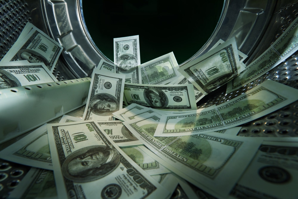 Washing banknotes in machine, money laundering, financial fraud concept