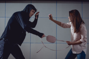 young woman defending herself against a robber